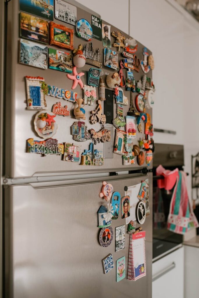 pexels photo 10252336 A collection of colorful souvenir magnets on a refrigerator in a modern kitchen.
