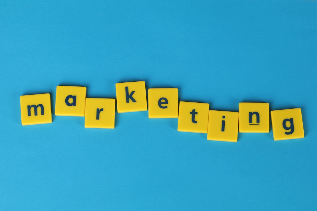 Bright yellow tiles spelling 'marketing' on a blue background, ideal for business themes.