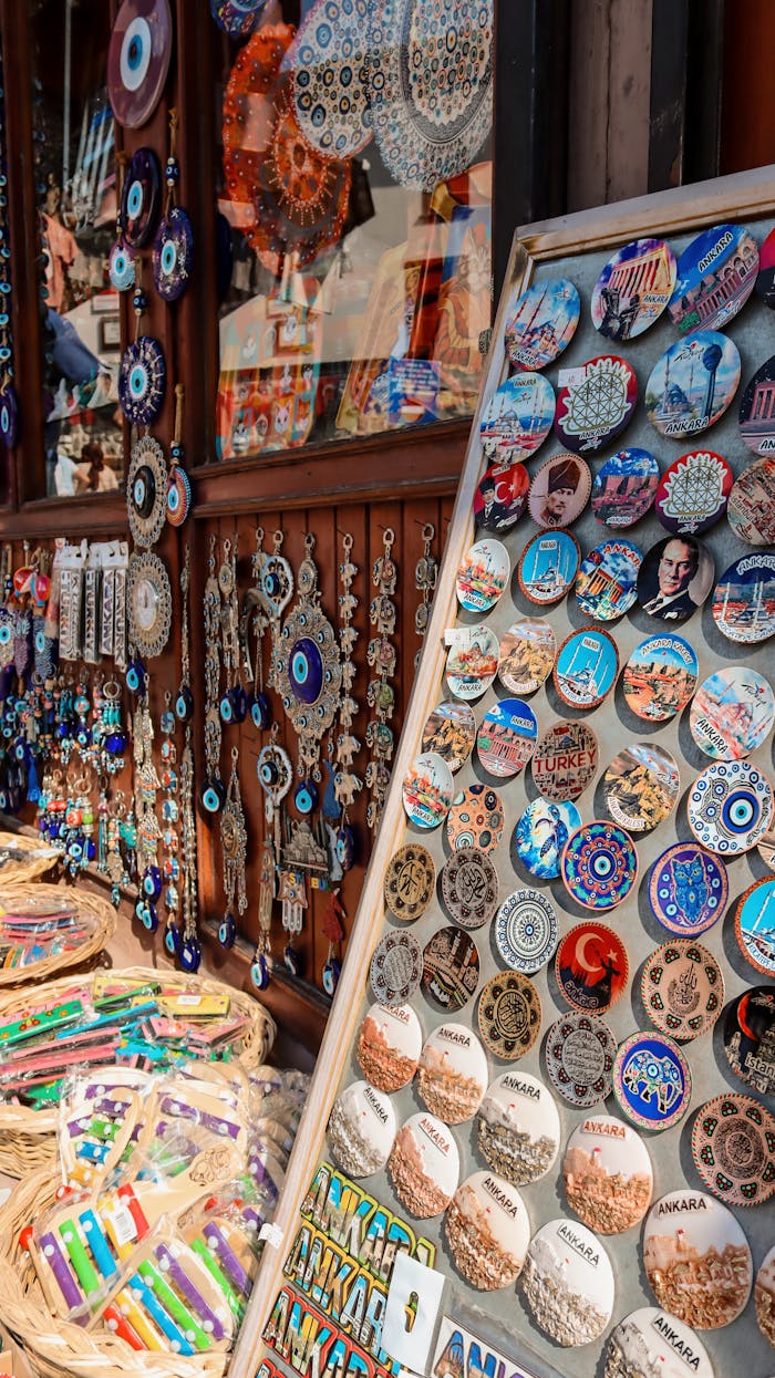Vibrant display of Turkish souvenirs with evil eye charms and magnets in a market setting.